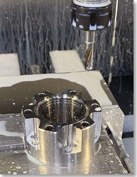 Figure 4. CNC fabrication in progress of flange features, with CF flange recess, knife edge, internal “grabber groove” channels being fabricated