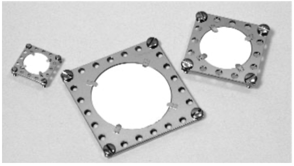 Examples of various sized Standard Phosphor Screens (0.7”, 1.4” and 2.0” Edge length) with conductive glass (0.5”, 1.0”, 1.5” diameter) screens  mounted in the central aperture of two adjacent square eV Part® plates. Tabs present to secure screens and conduct away charge.  